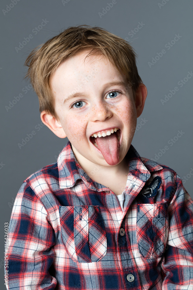 smiling young boy having fun in sticking out his tongue smiling young boy having fun in sticking out his tongue