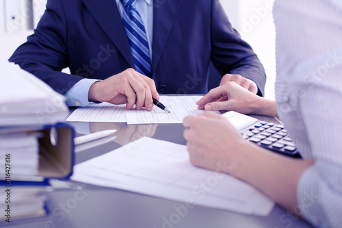 Obraz na płótnie Bookkeepers or financial inspector making report, calculating or checking balance