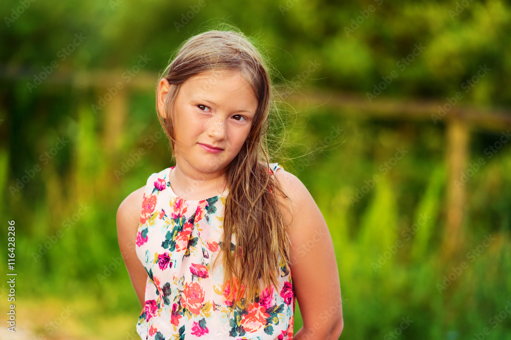 Outdoor portrait of a cute little girl of 8 years