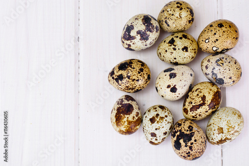 Quail Eggs on Light Wood Background
