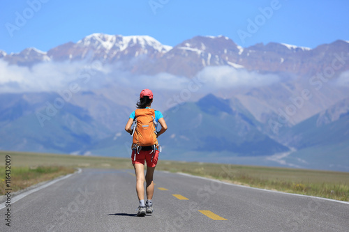 young woman hiker hiking at beautiful mountain trail