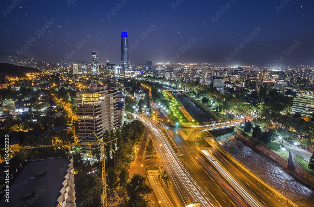 Fototapeta premium Night view of Santiago de Chile toward the east part of the city, showing the Mapocho river and Providencia and Las Condes districts
