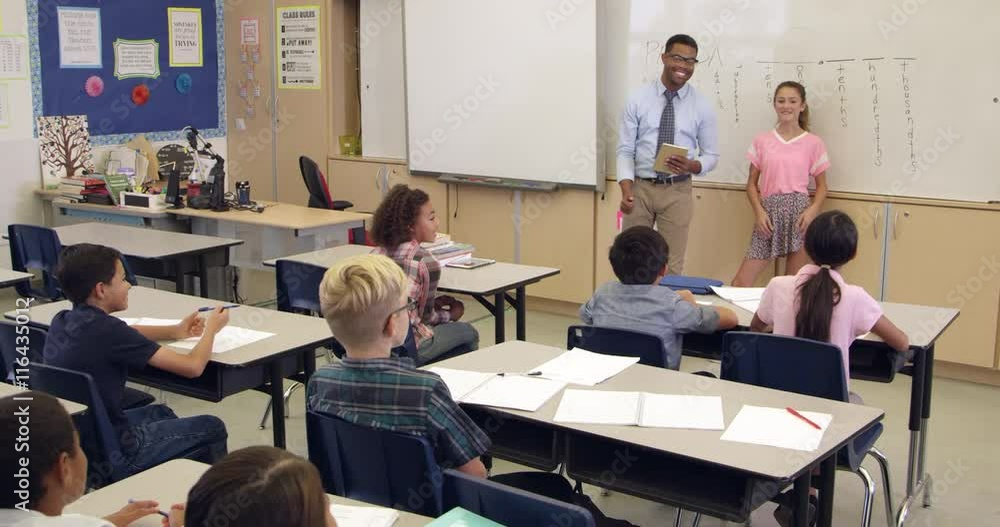 Schoolgirl answering question at front of class, Schoolgirl answering question at front of class,