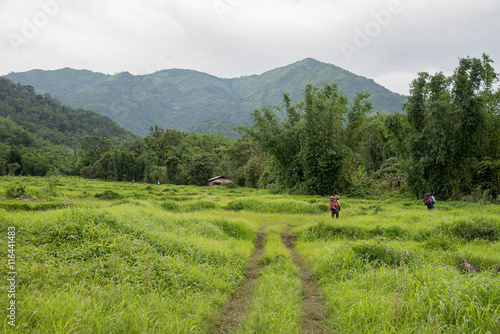 Man Traveler with big backpack mountaineering Travel to the Pre To Lo Su or Pi Tu Kro waterfall heart-shaped waterfall Umphang Tak ,Thailand. photo