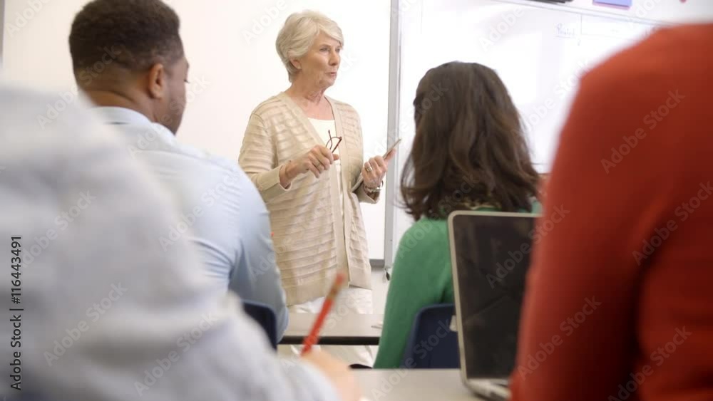 Senior woman with tablet teaching adult education class Senior woman with tablet teaching adult education class
