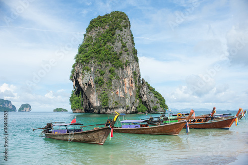 Poda Island, Speed boats and Thai traditional boat anchored in a amazing blue water beach in Krabi, Thailand. © jitpitak