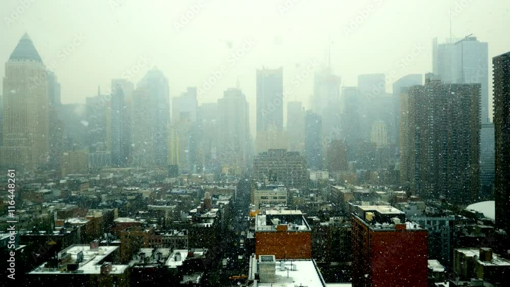 snow falling in new york city. winter season weather. skyline panorama