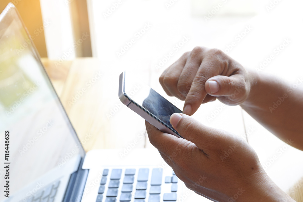 Close up image of man`s hand is touching finger of mobile phone Close up image of man`s hand is touching finger of mobile phone