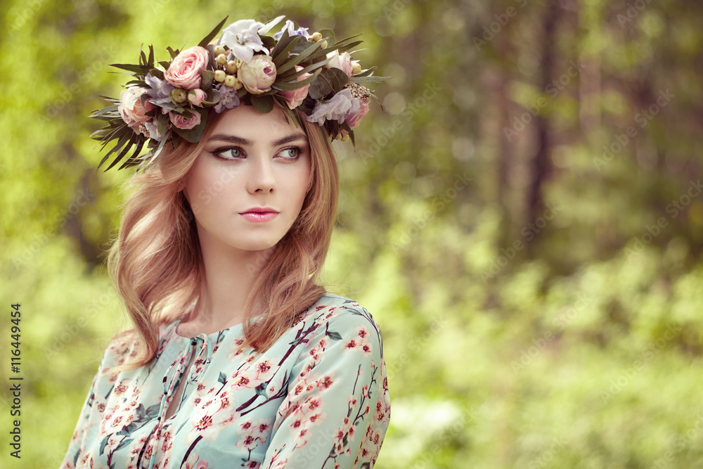 Beautiful blonde woman with flower wreath on her head. Beauty girl with flowers hairstyle. Girl in a summer forest. Fashion photo Beautiful blonde woman with flower wreath on her head. Beauty girl with flowers hairstyle. Girl in a summer forest. Fashion photo