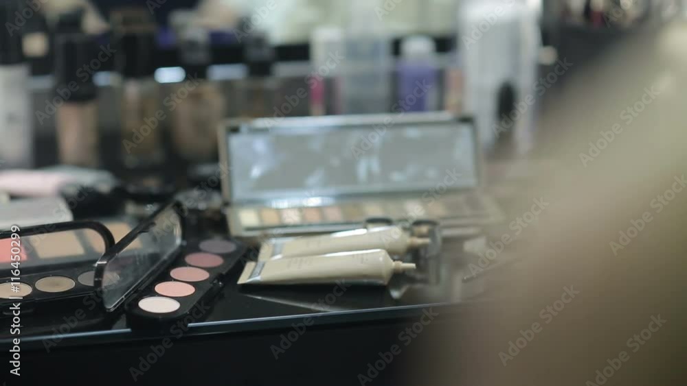 Open MakeUp palette lying on the table in front of a mirror stylist Open MakeUp palette lying on the table in front of a mirror stylist