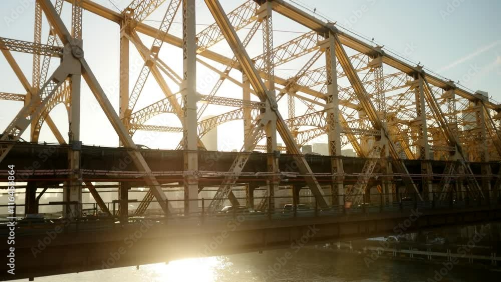 sun shining through bridge silhouette. traffic road transportation