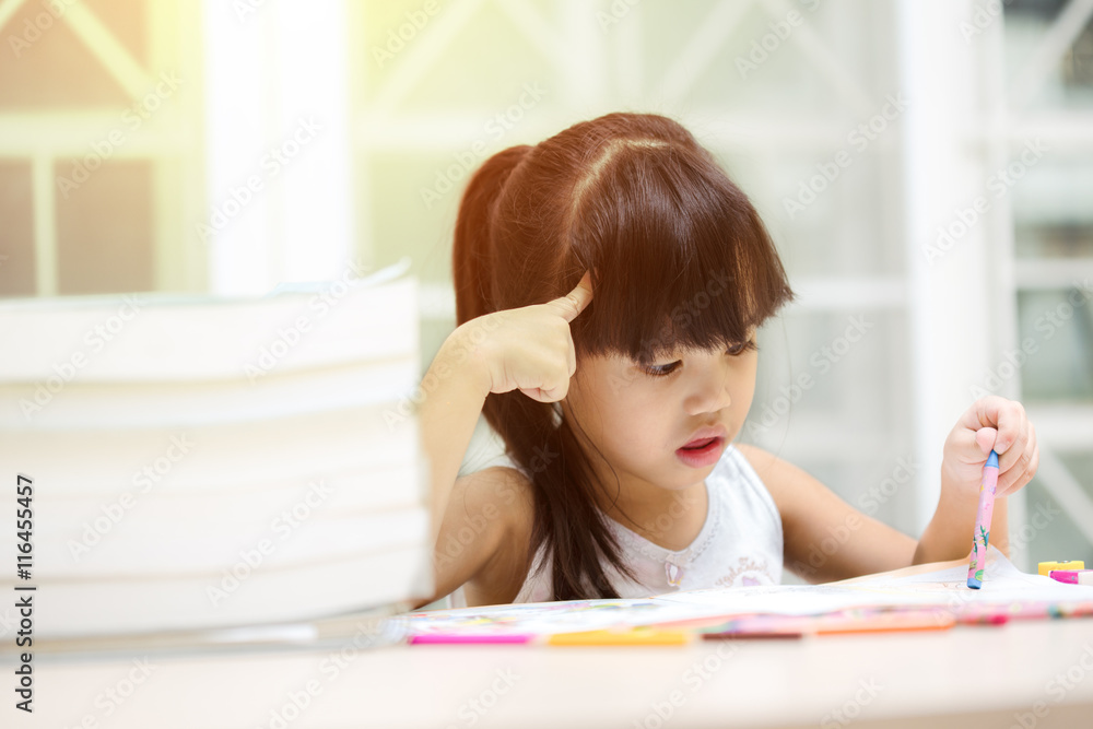 Thoughtful girl reading a book and using her imagination Thoughtful girl reading a book and using her imagination
