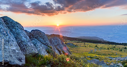 Black Peak (Cherni Vrah) on Vitosha mountain, Bulgaria - 2290 m. Last rays of sunlight through the rocks. photo