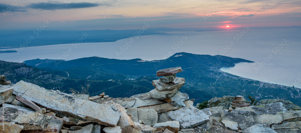 Thassos Island, Greece - view from Mount Ipsarion - little stone pagoda in the middle and first rays of the rising sun - obrazy, fototapety, plakaty 