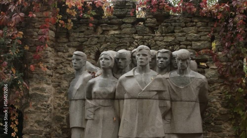 Monument to Fallen Heroes on a Background of Stone Wall Outside photo