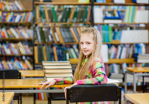 happy teen girl with book look back in library