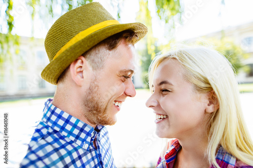 Young happy couple hugging and laughing..beautiful young couple fooling around in the park © mintybear