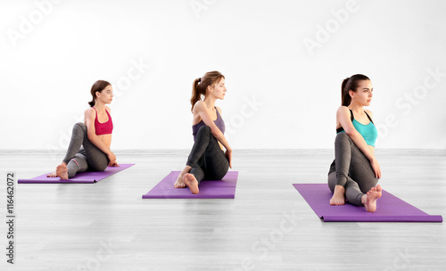 Young women with mats in gym