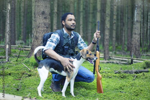 Interracial hunter in the forest with his dog