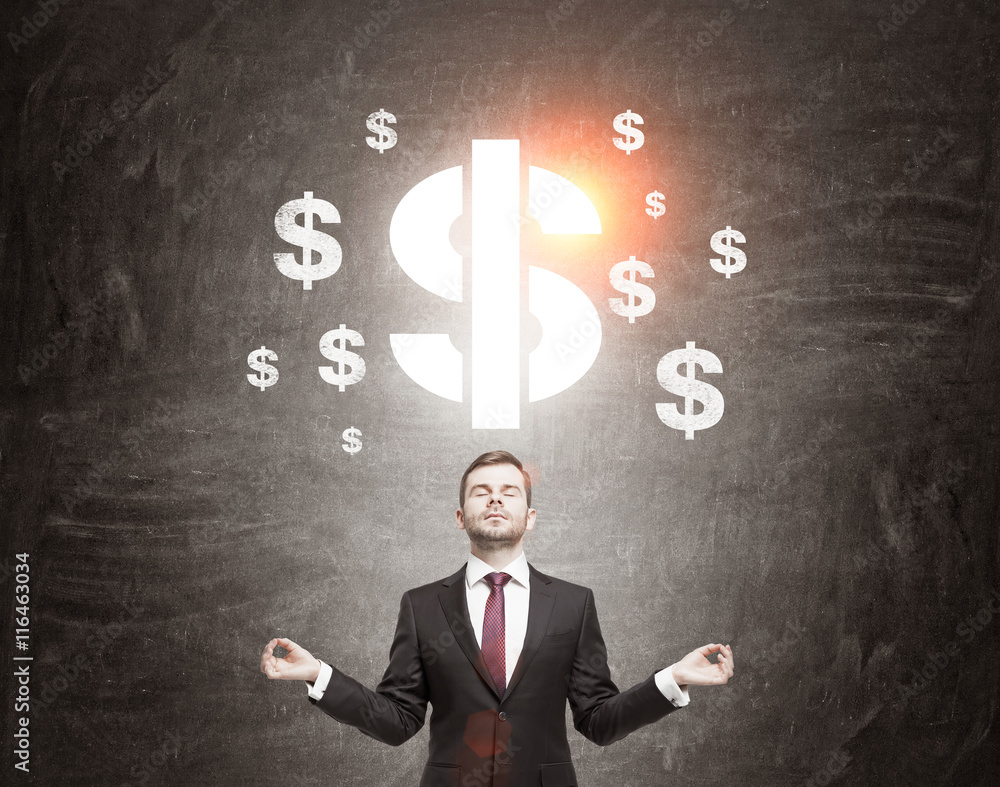 Businessman meditating in front of dollar signs sketch