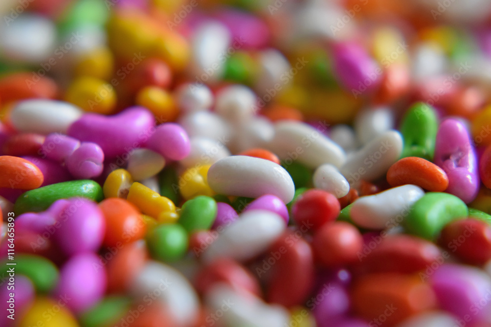 Close-up of colorful sugar coated fennel seed Indian candy filling background Close-up of colorful sugar coated fennel seed Indian candy filling background