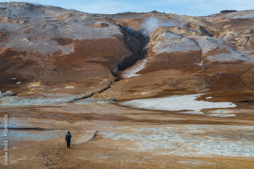 NÃ¡mafjall geothermal area of Northeast Iceland. At this area, also known as Hverir, you may see many solfataras and boiling mud pots, surrounded by sulfur crystals of many different colours. photo