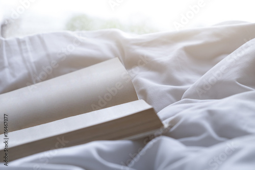 Empty page book on soft bed in the morning.