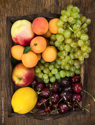 Different fruits in wooden tray