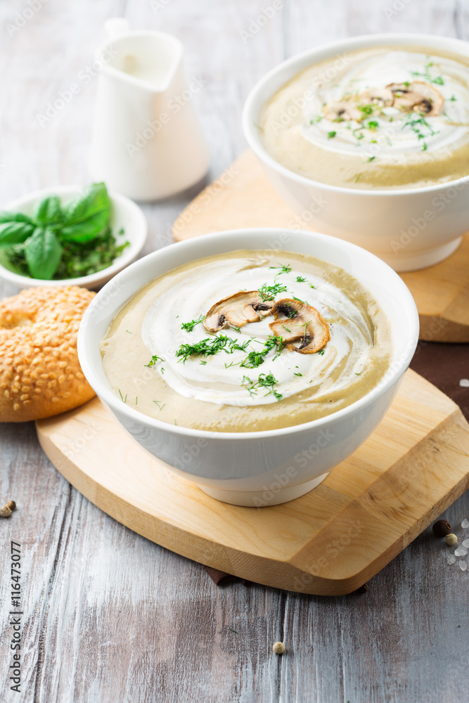 Homemade Mushroom cream soup on a white wooden table Homemade Mushroom cream soup on a white wooden table