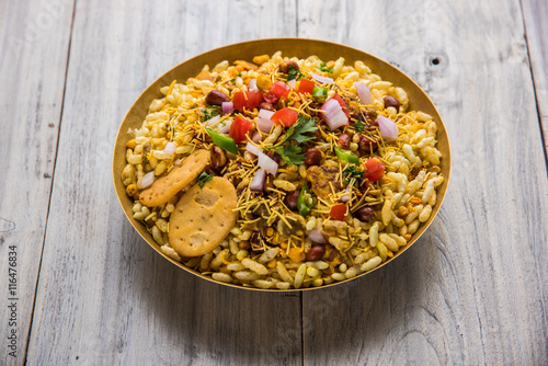 Indian snacks Bhel Puri served with chopped tomatoes, green chillies, coriander leaves photo