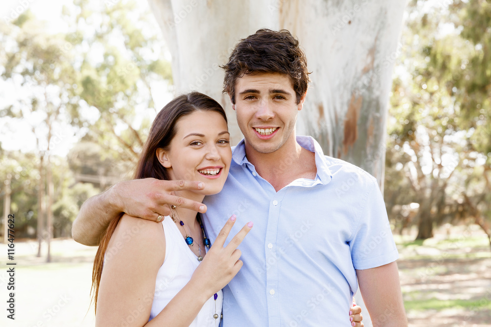 Young couple in the park celebrating Young couple in the park celebrating
