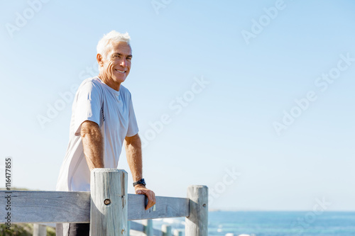Man standing on beach in sports wear