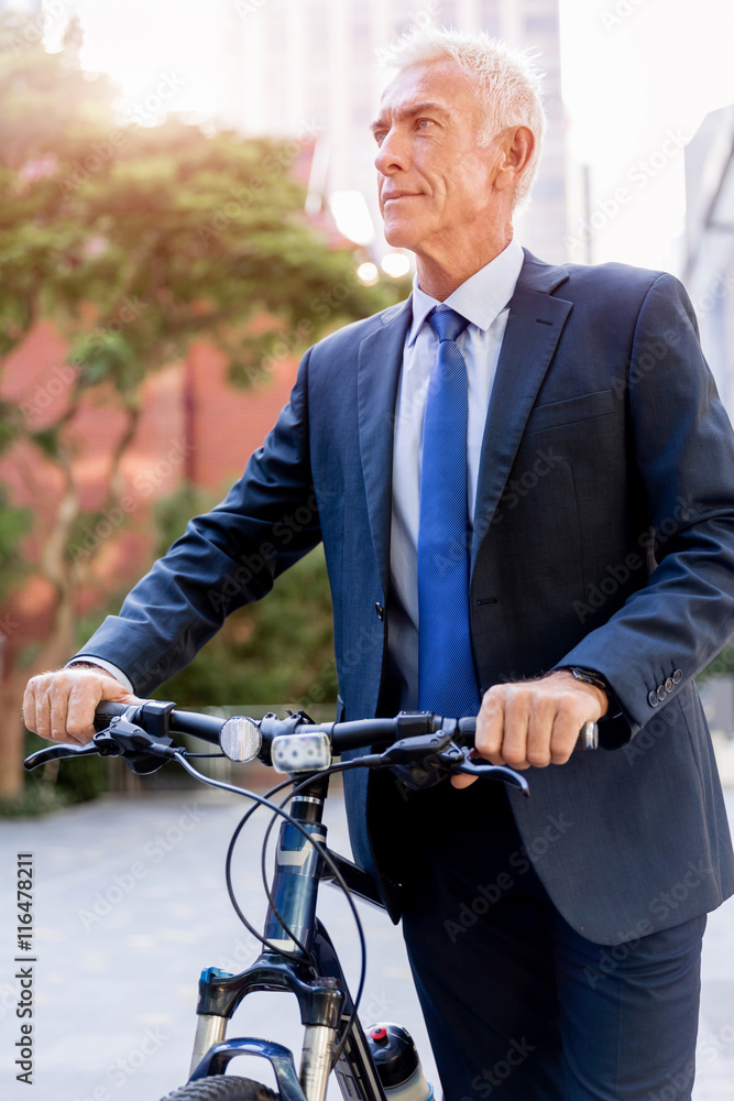 Fototapeta premium Successful businessman riding bicycle