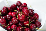 Close up of fresh ripe cherries in a white bowl