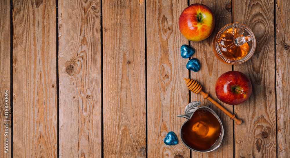 Rosh Hashana holiday background with honey, apples and chocolate on wooden table. View from above. Flat lay Rosh Hashana holiday background with honey, apples and chocolate on wooden table. View from above. Flat lay