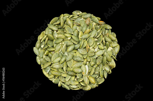 Pumpkin seeds on a black background.