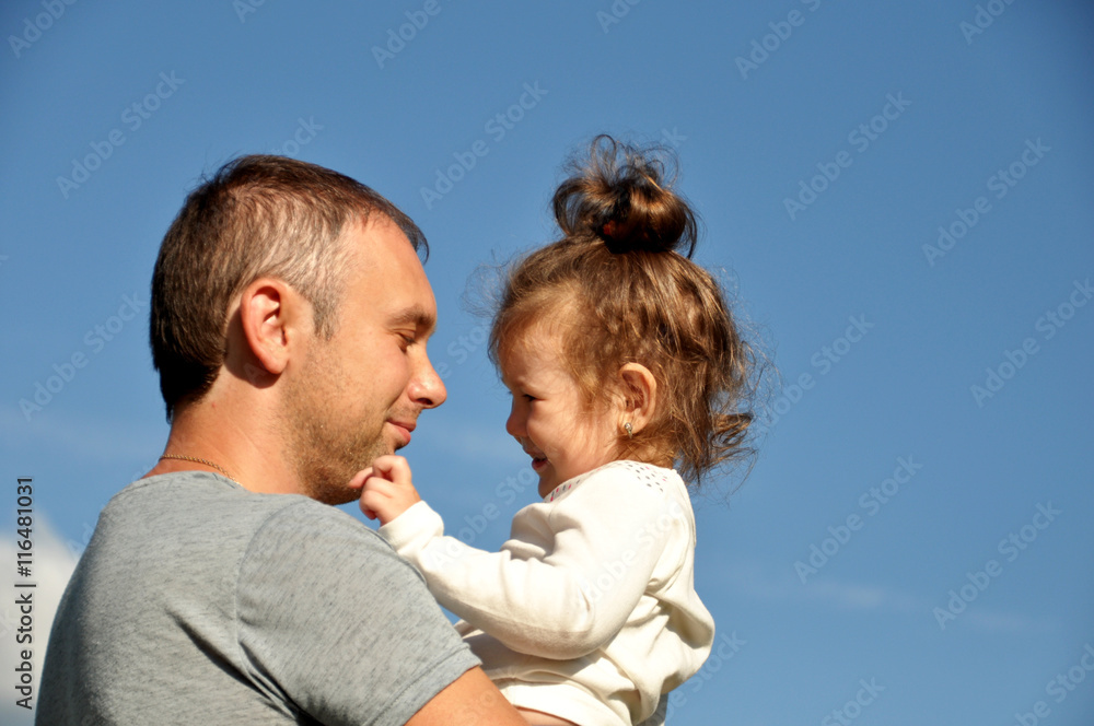 Happy father with his daughter outdoors hugging together Happy father with his daughter outdoors hugging together