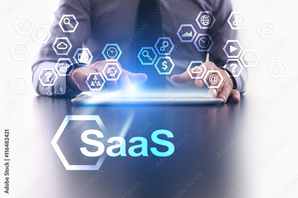 Businessman is using tablet pc and selecting SaaS icon. Businessman is using tablet pc and selecting SaaS icon.