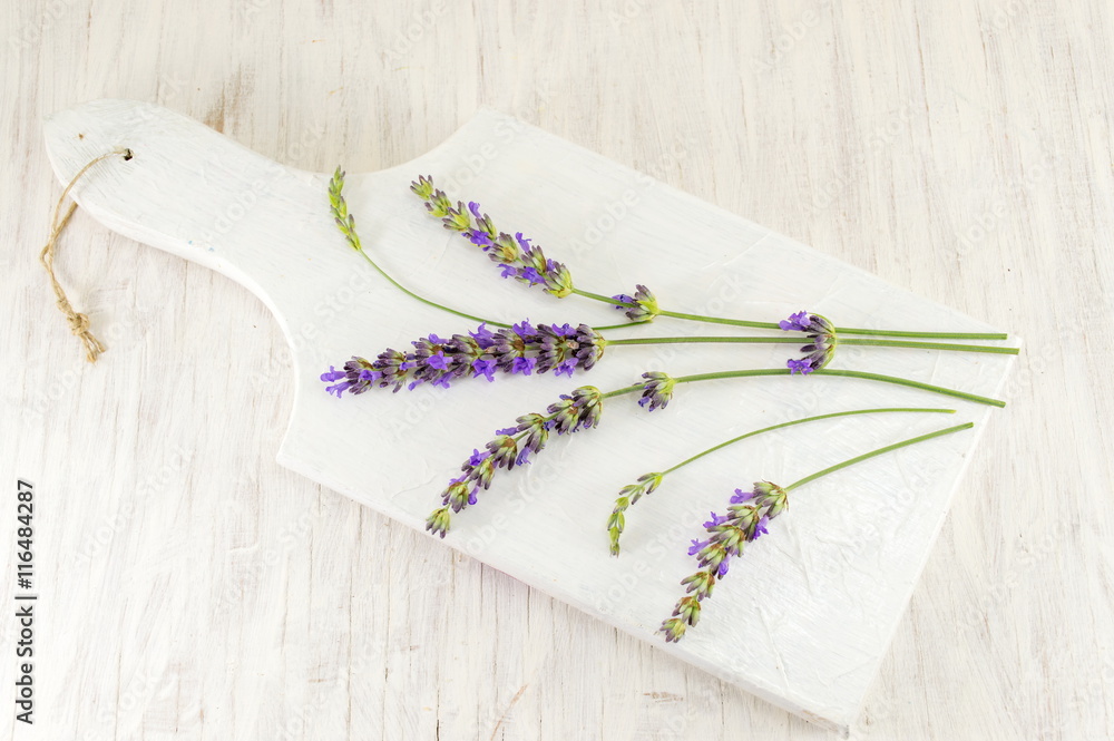 Fototapeta premium Lavender flower branches on wooden tray