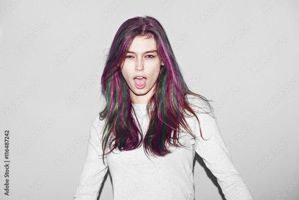 Emotional hipster girl make funny face experiment with green hairs color on light background Emotional hipster girl make funny face experiment with green hairs color on light background