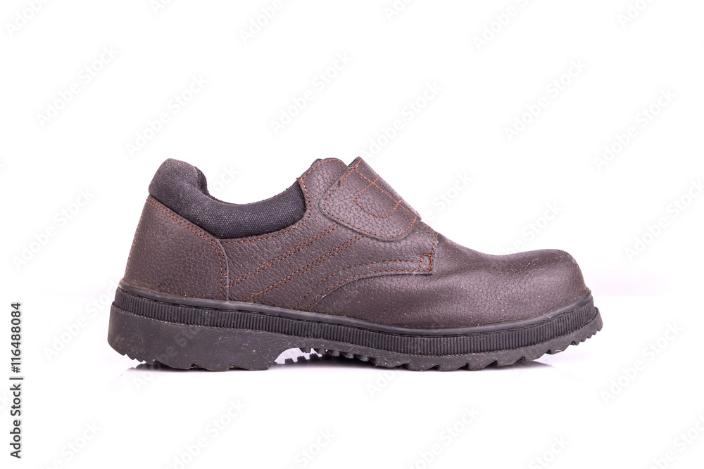 Old black safety shoe isolated on white background Old black safety shoe isolated on white background
