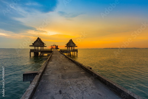 Waking path leading to ocean with beautiful dramatic sunset sky background, natural landscape photo