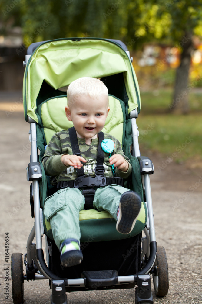 Little boy sitting in stroller Little boy sitting in stroller