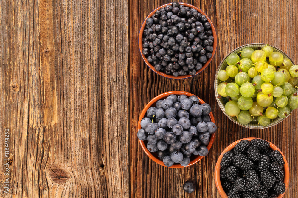 Fresh blueberries and blackberries on old wooden background Fresh blueberries and blackberries on old wooden background