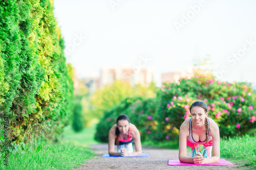 Sport fitness women training push-ups. Female athlete exercising push up outside in empty park. Fit girl fitness model in crossfit exercise outdoors. Healthy lifestyle concept.