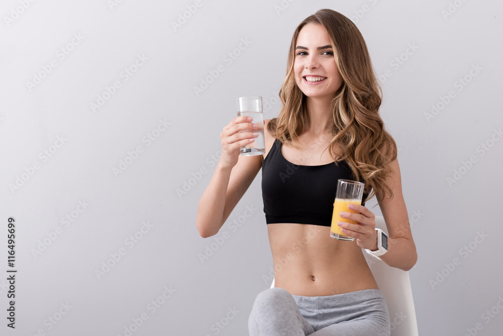 Positive smiling woman holding drinks Positive smiling woman holding drinks