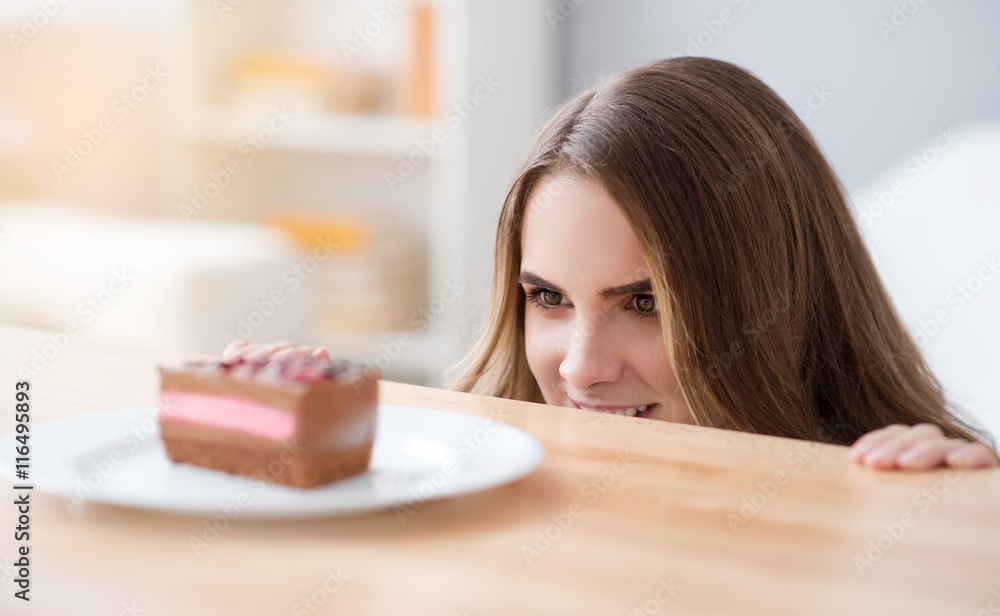 Positive woman looking out of the table Positive woman looking out of the table