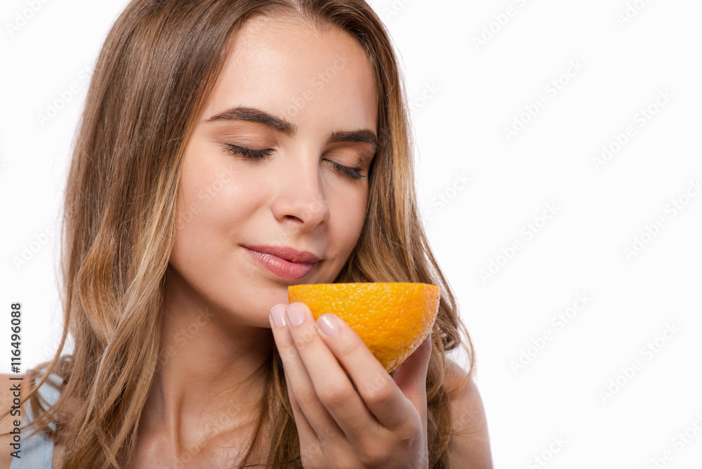 Delighted woman holding orange Delighted woman holding orange