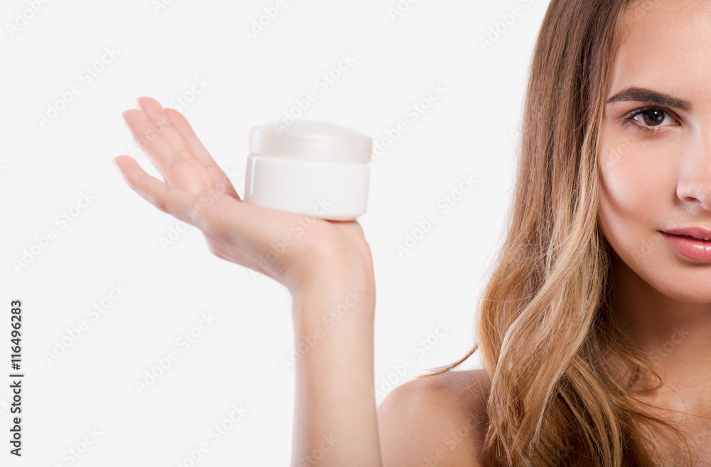 Pleasant beautiful woman holding face cream Pleasant beautiful woman holding face cream
