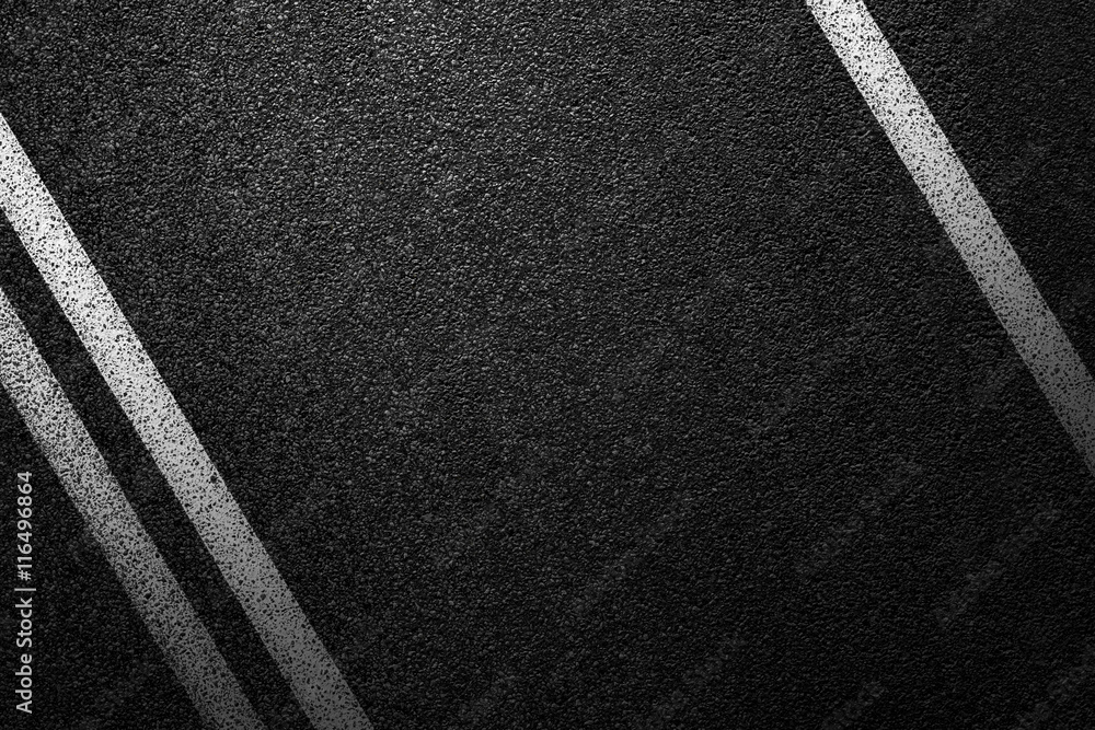 Fototapeta premium Level asphalted road with a dividing white stripes. The texture of the tarmac, top view.